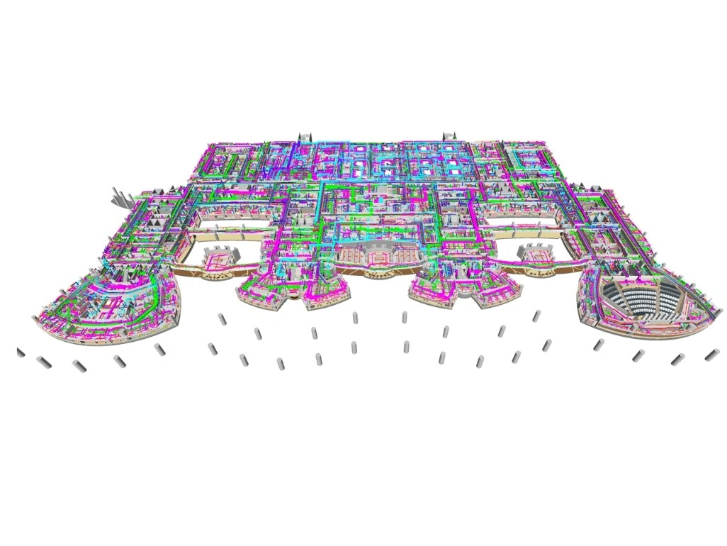 Architects collaborating on a 3D BIM model in an office in New York City, showing structural, MEP, and architectural layers on computer screens.